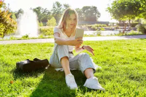Young woman talking on the phone during a video chat on Omegle, smiling and making eye contact with the screen.