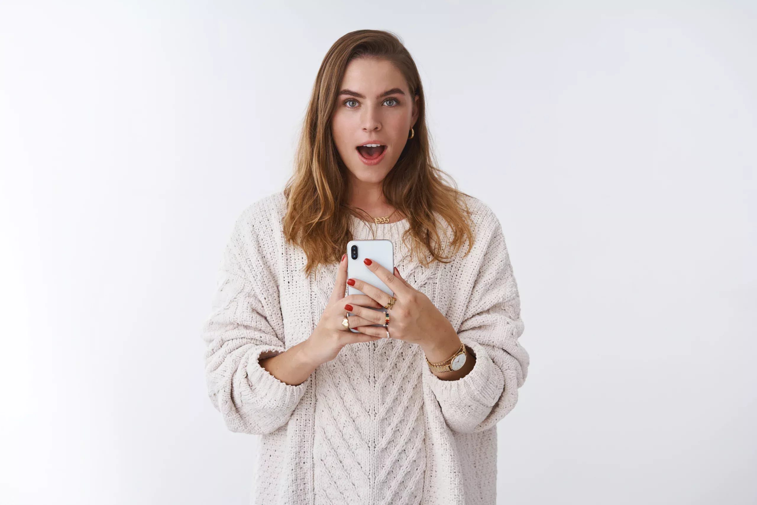 Woman holding a smartphone while reading news about whether Omegle is coming back